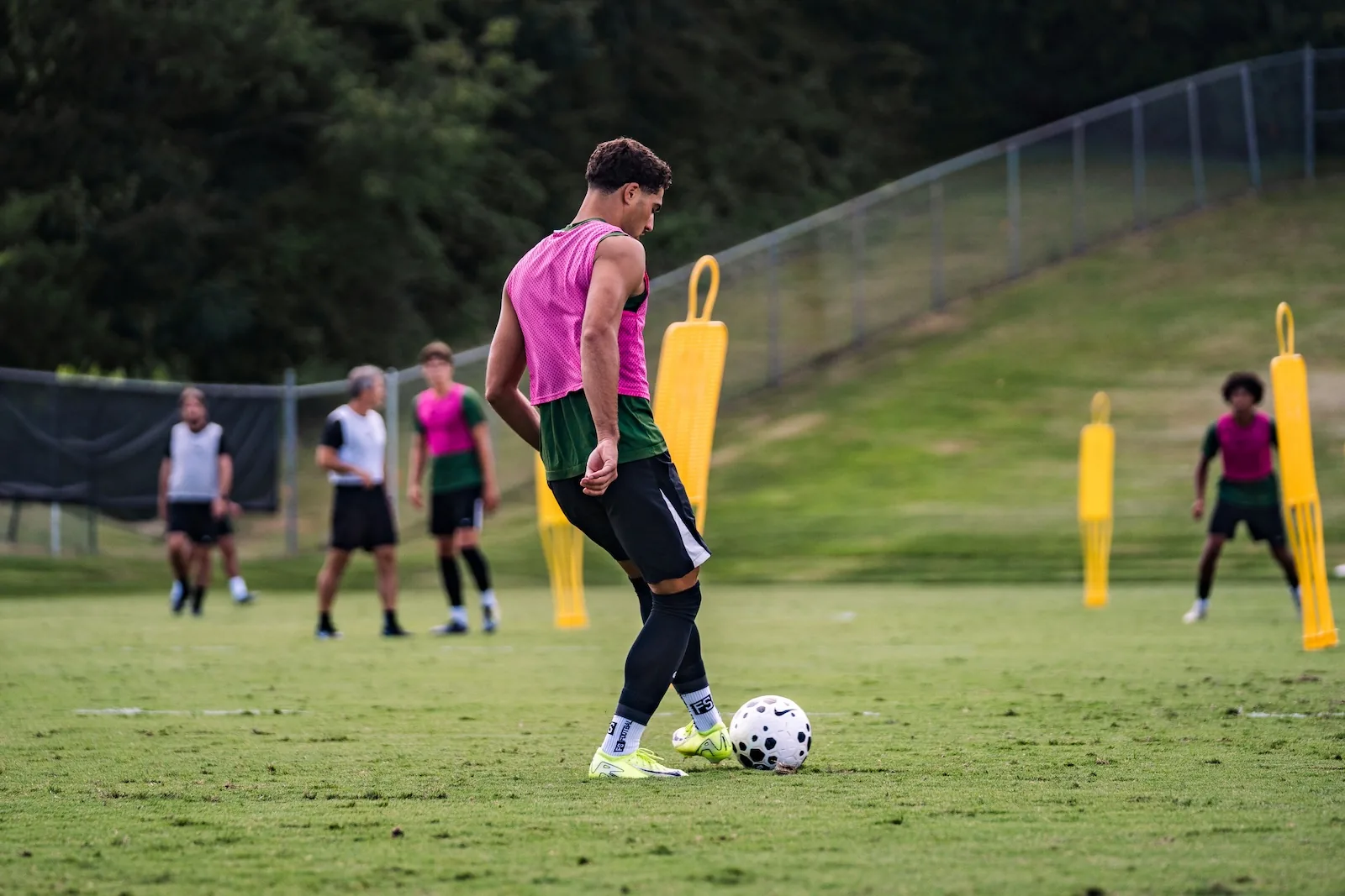 Student athlete training session at college soccer pitch
